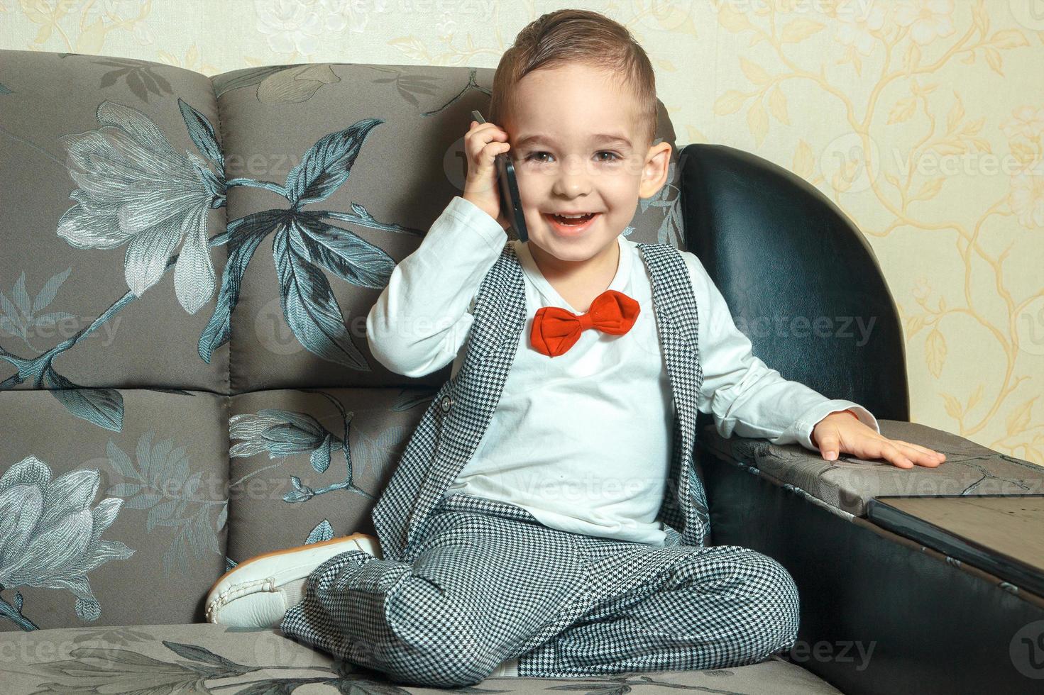 happy young boy smiling and talking phone photo