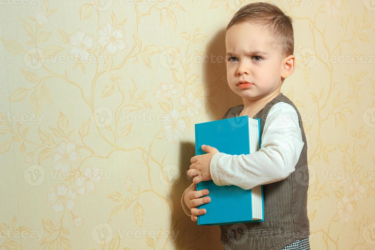 little boy with book in hands photo