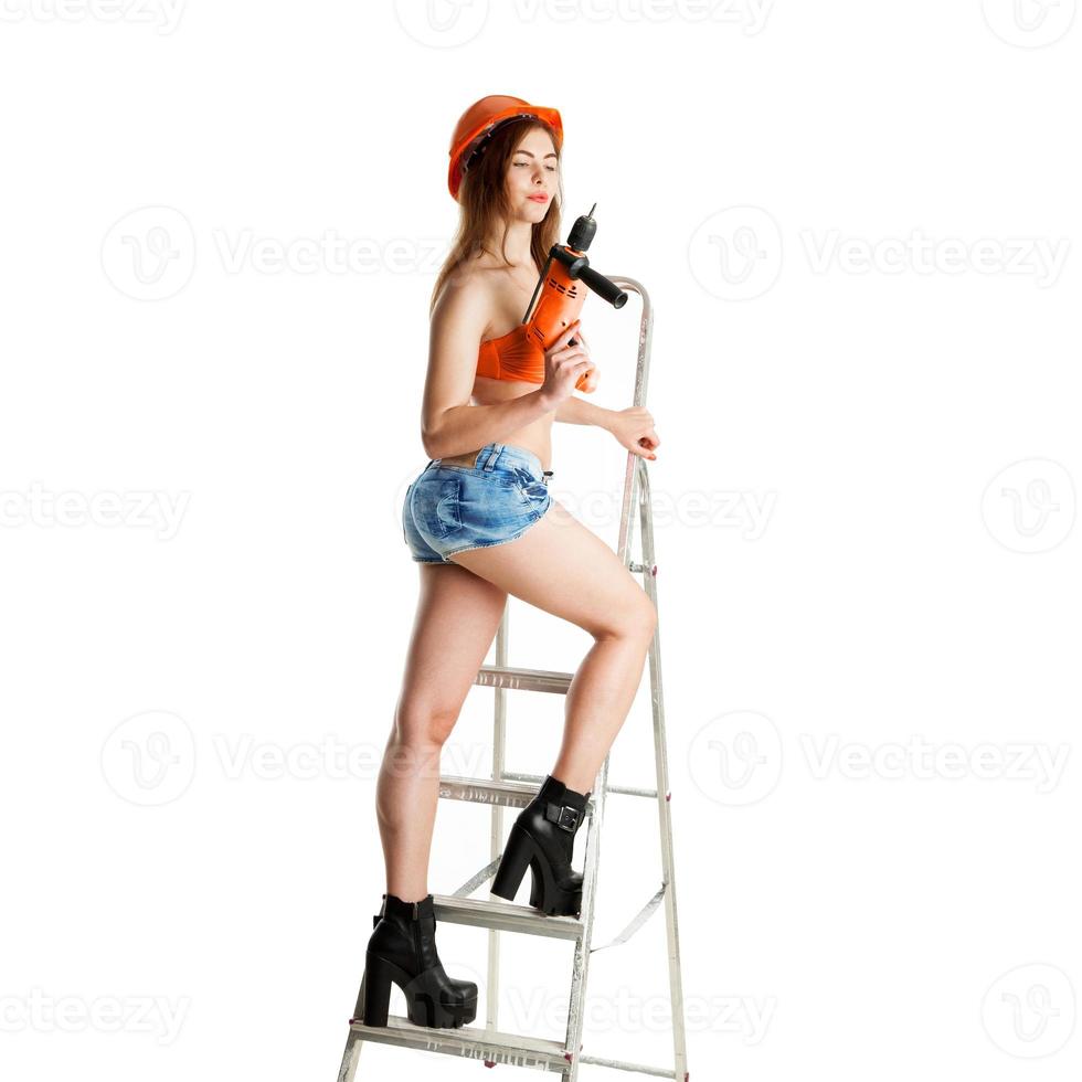 young brunette female builder in helmet photo