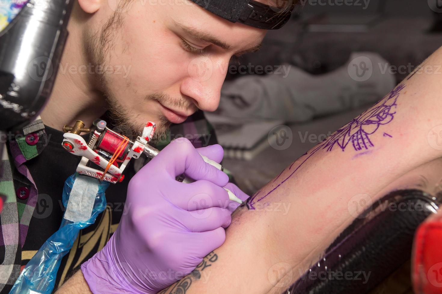 Tatooer is making tatoo photo