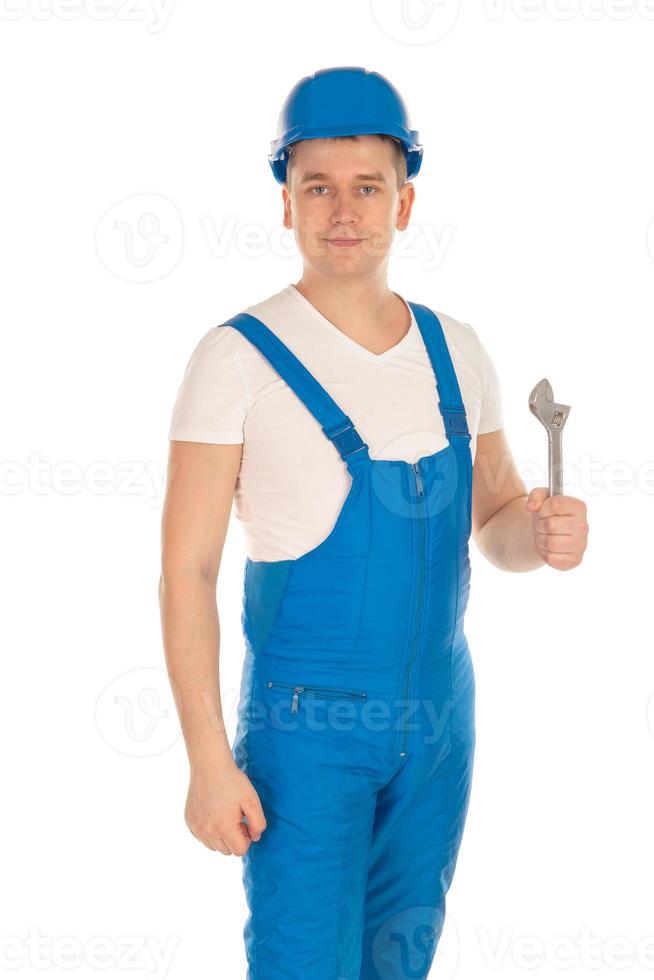 builder in blue uniform with tools in hand photo