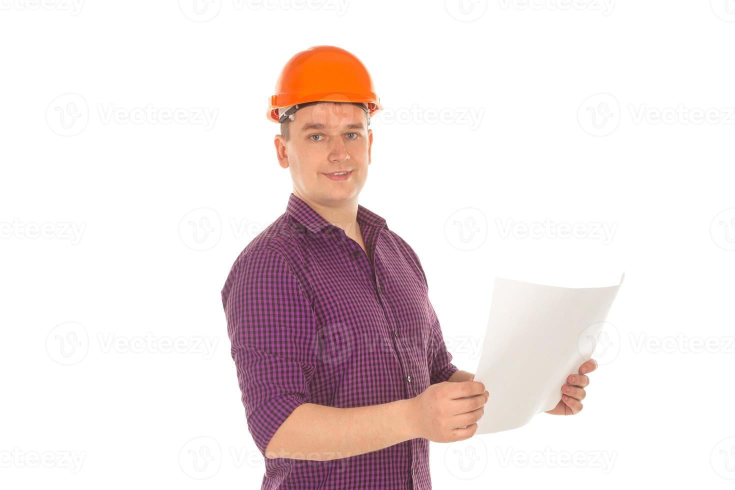 cheerful builder in helmet with plan in hands photo