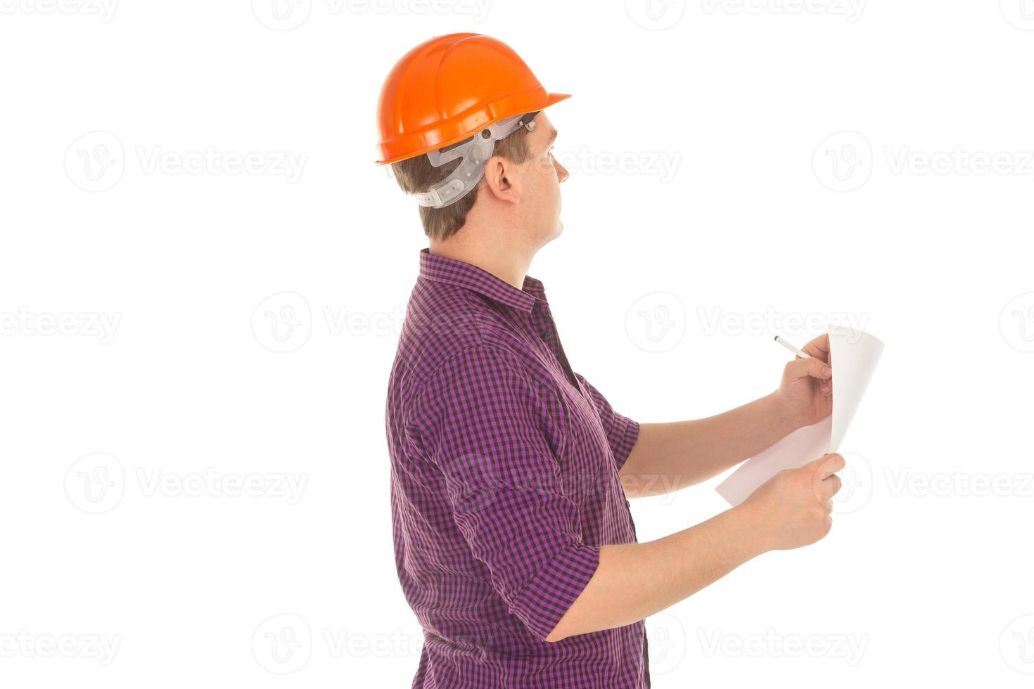 builder in hardhat with plan in hands photo