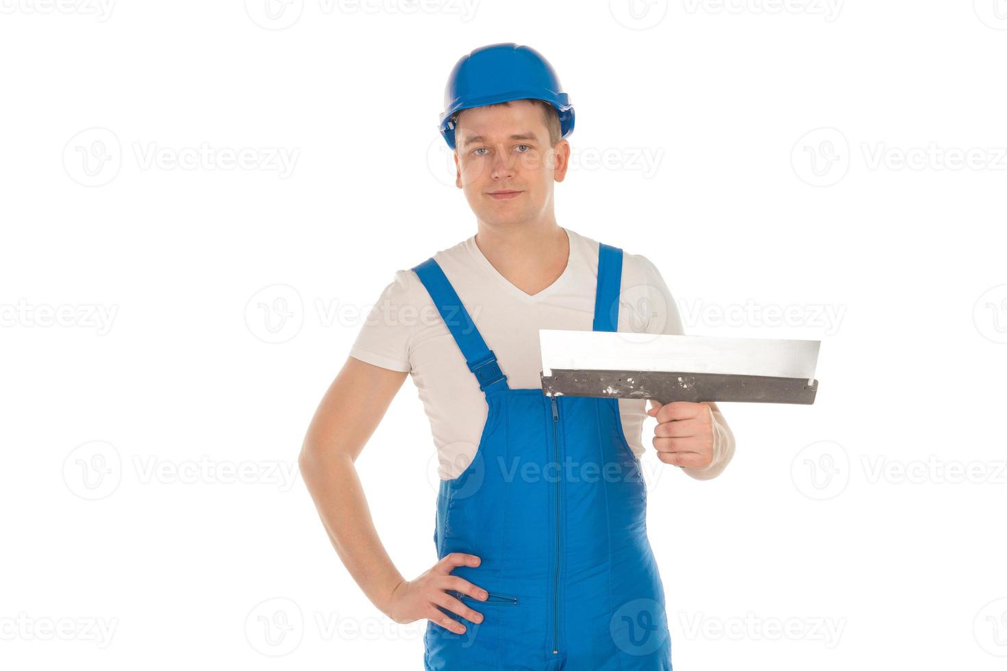 builder in blue uniform with putty knife photo