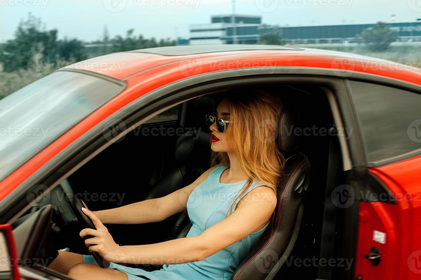 young lady driving car photo