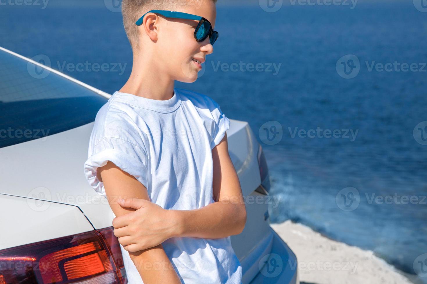 stylish young boy in sunglasses photo