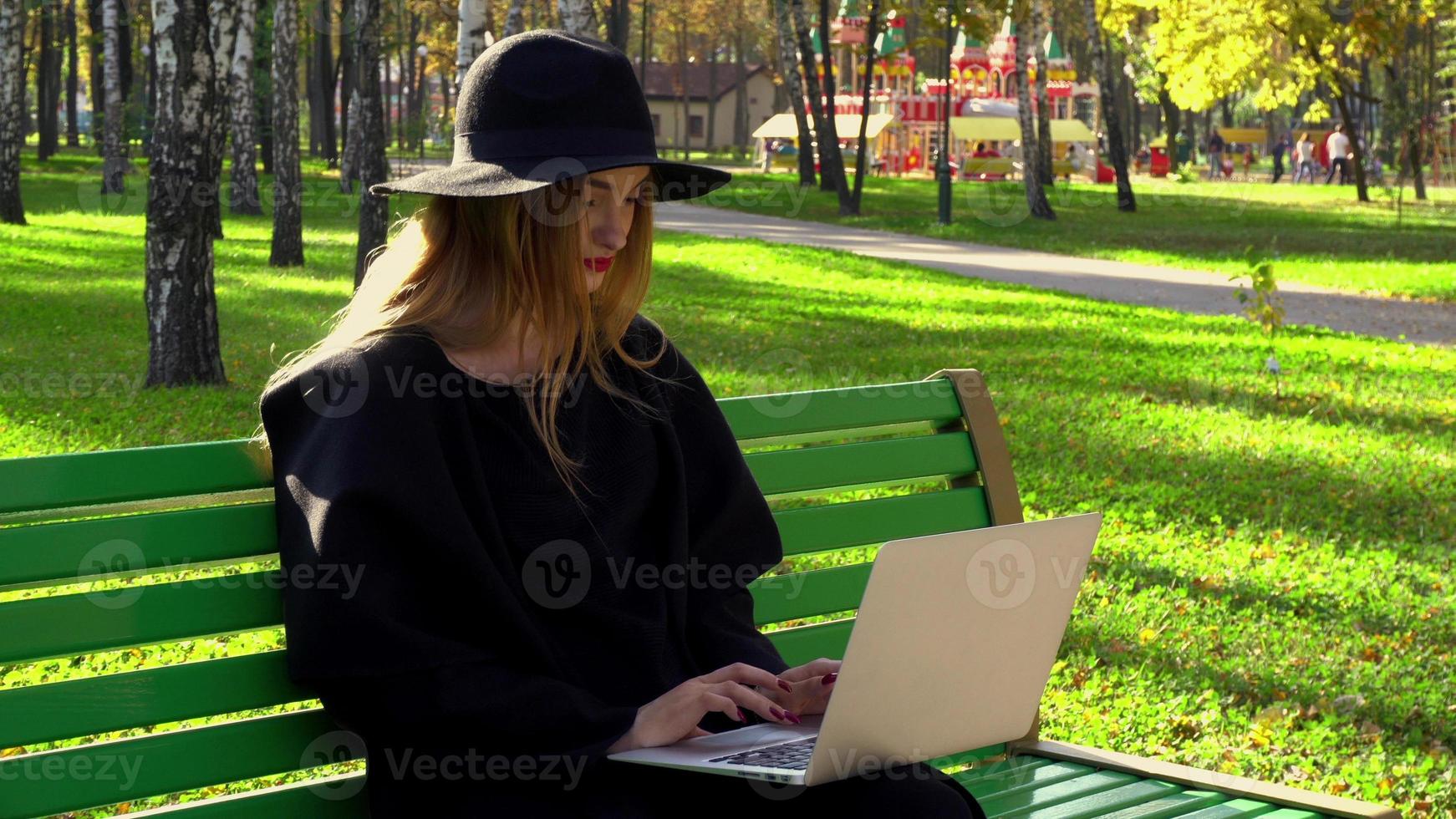 oung blogger typing on laptop photo