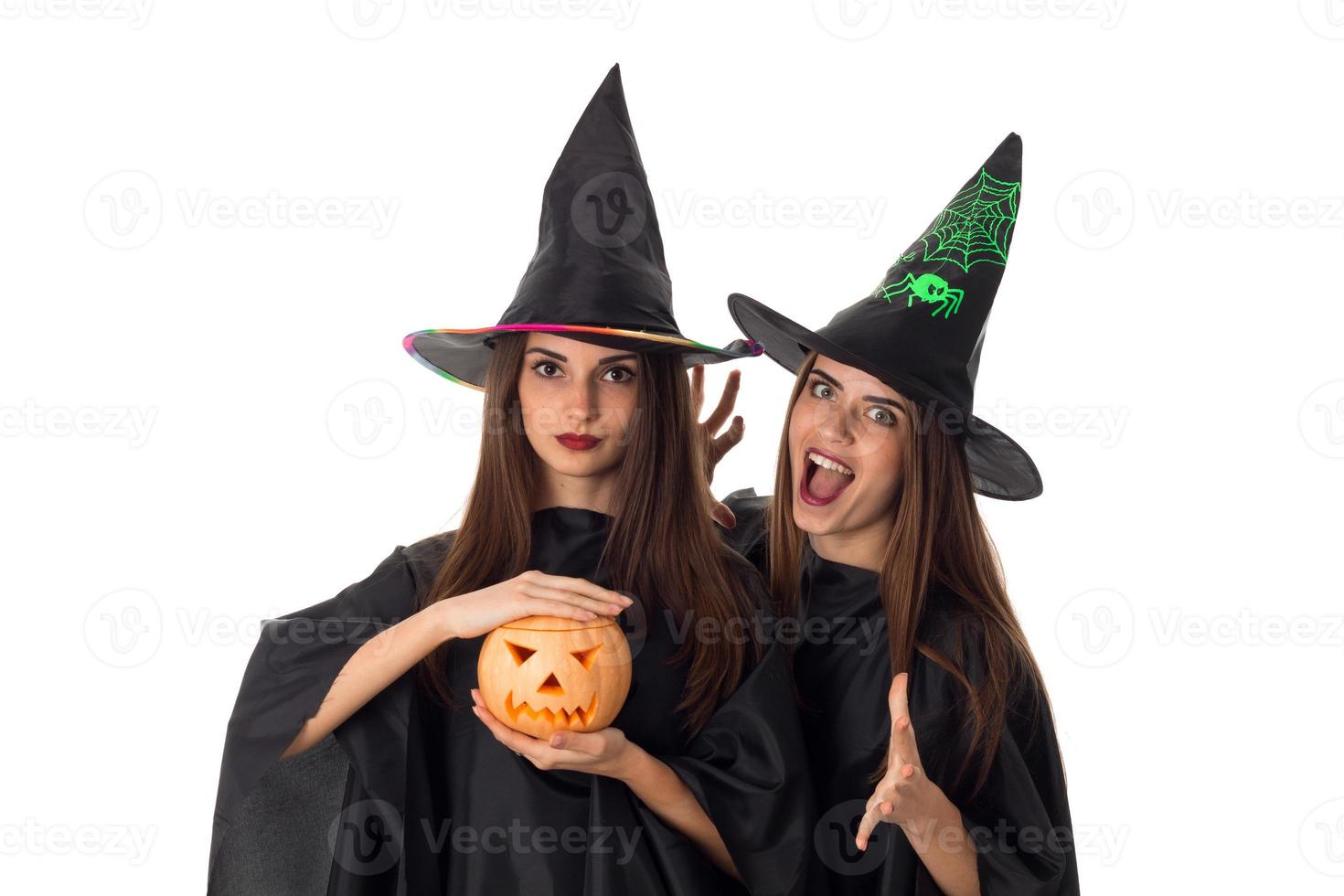 joyful young women with pumpkins in hands photo