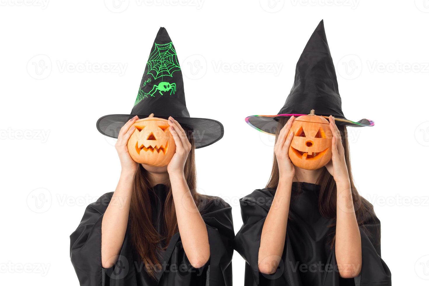 young girls with pumpkins in hands photo