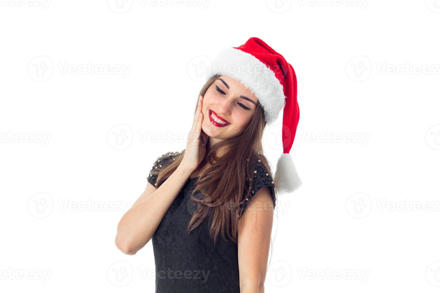 girl in santa hat with closed eyes photo