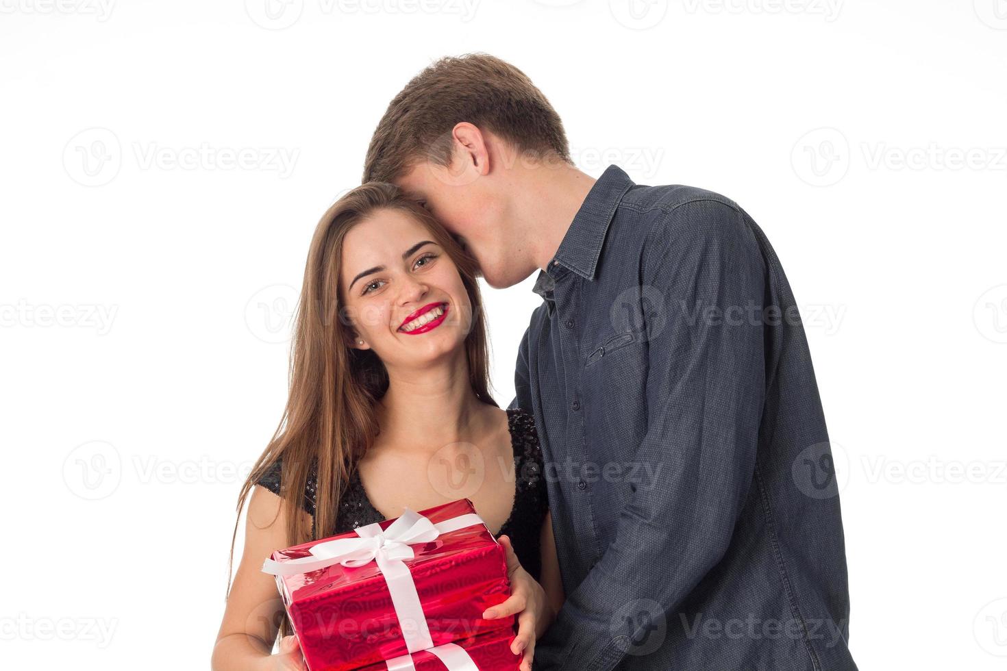 young beautiful couple with gift in hands photo