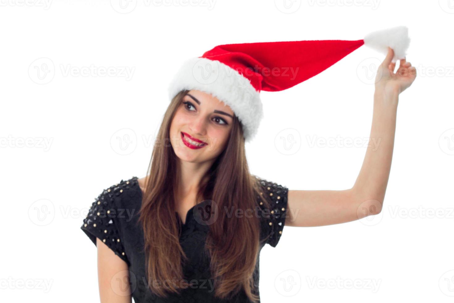 young brunette girl in santa hat photo