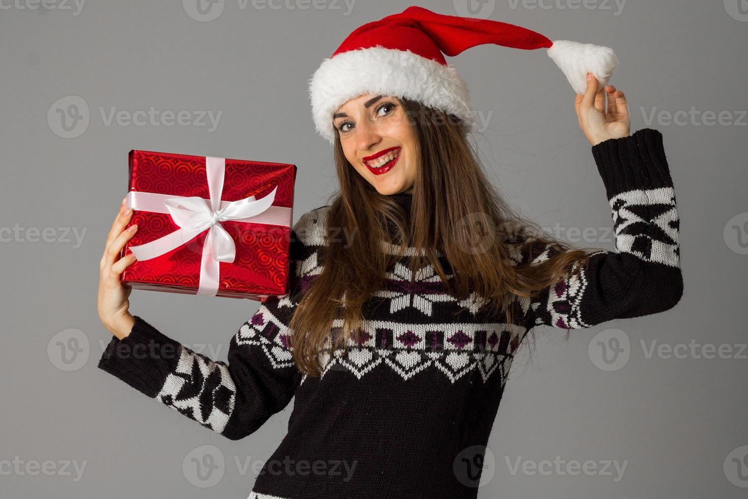 woman in warm sweater and santa hat photo