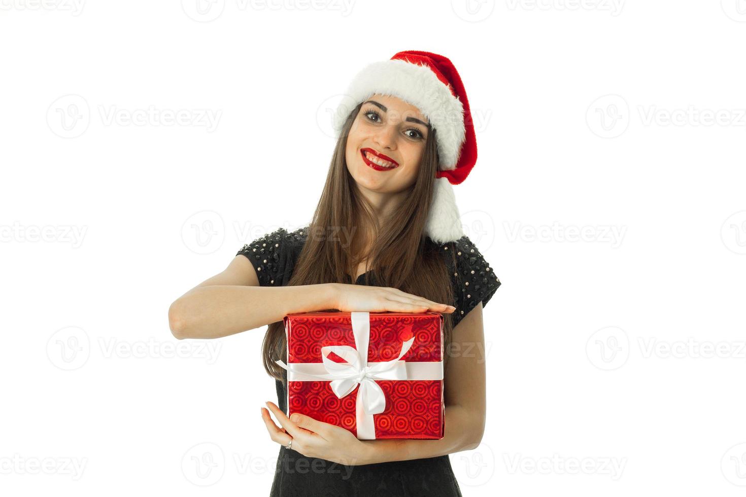 stylish girl in santa hat with red gift photo