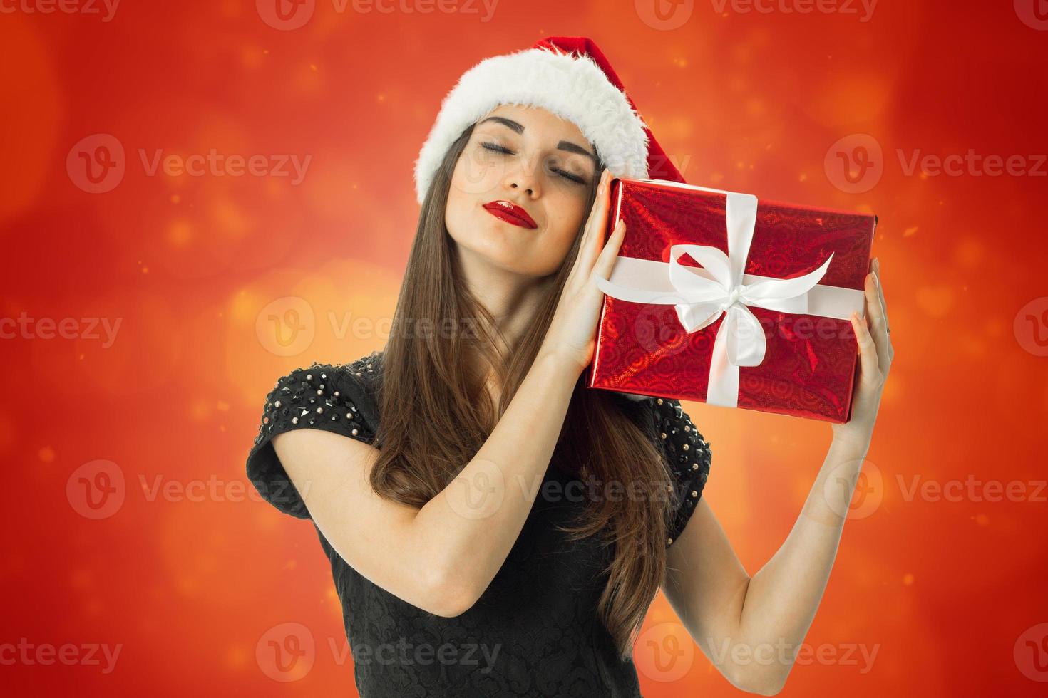 adorable Girl in santa hat with closed eyes photo