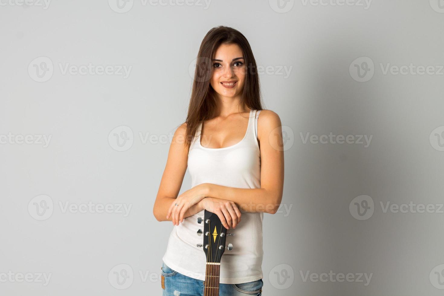 woman with big breasts holding a guitar photo