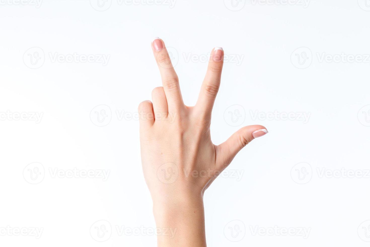 female hand showing the gesture with three fingers photo