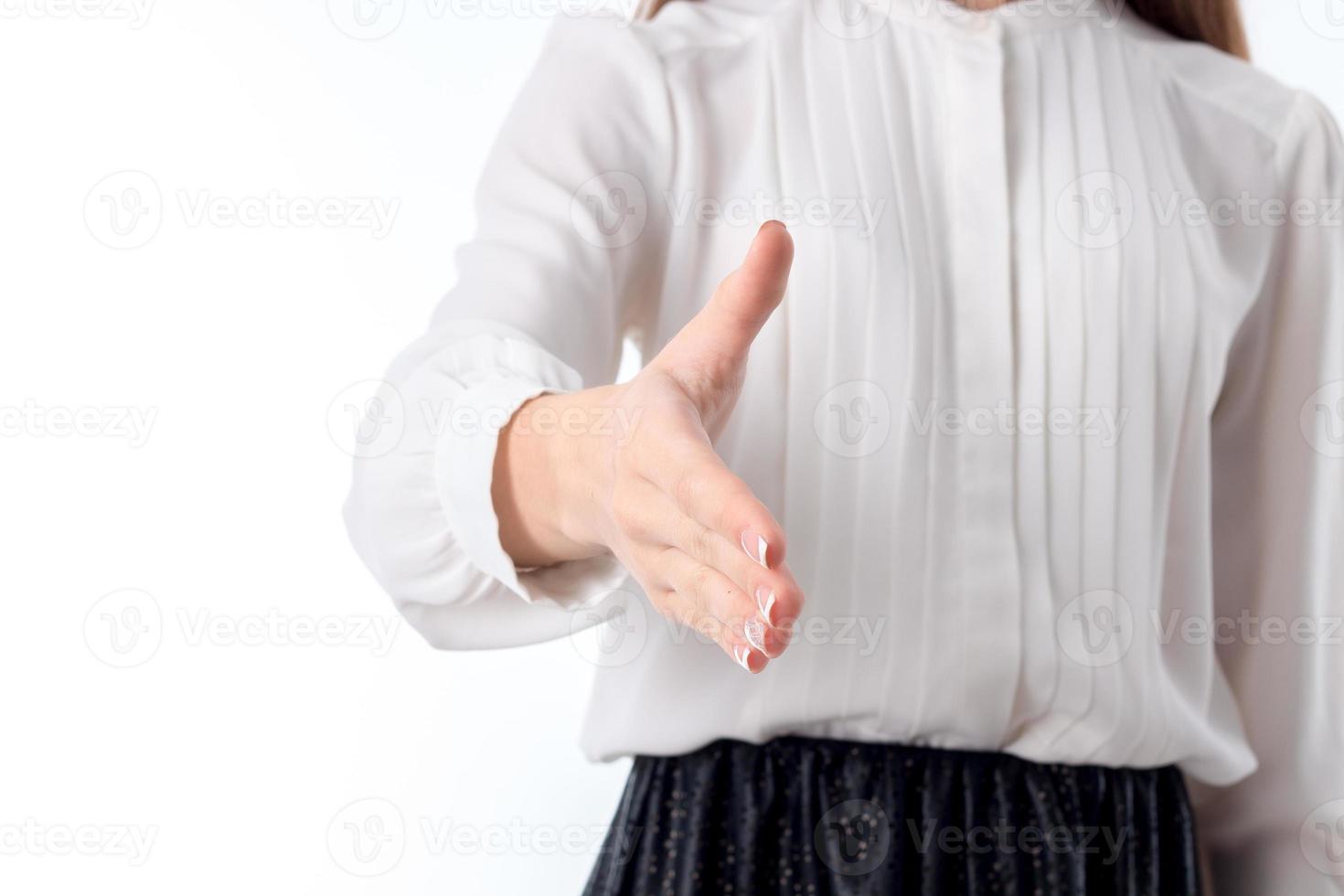 the girl in the white blouse reaches out forward to greet the photo