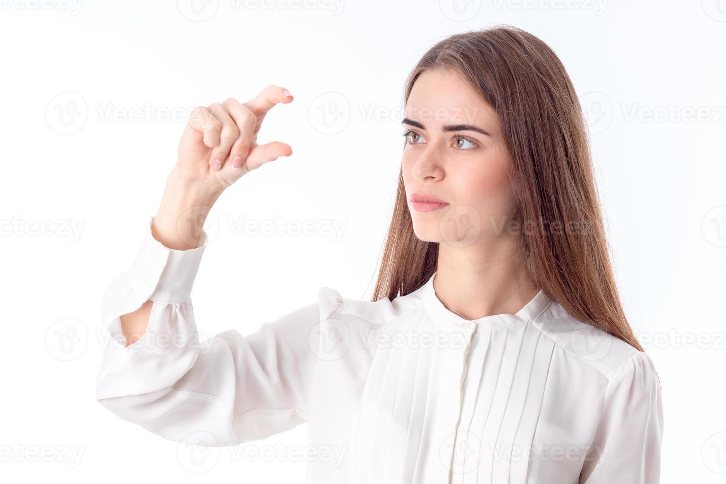 young girl in white shirt raised one arm up with bent fingers isolated on  background photo