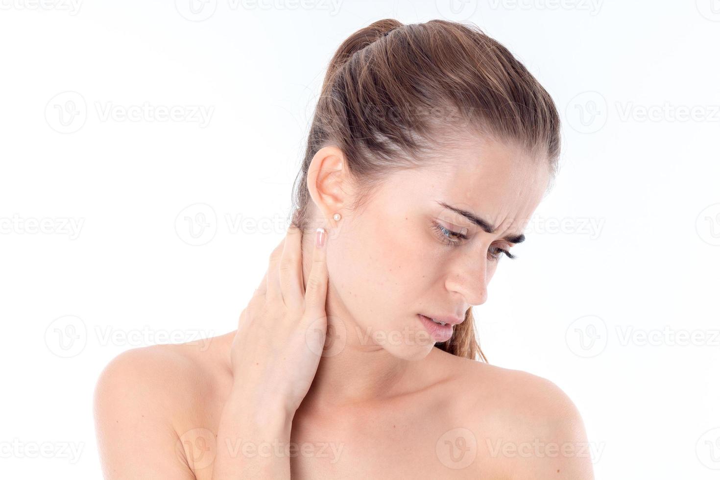 young girl holds hand behind the neck and lowered down her head
