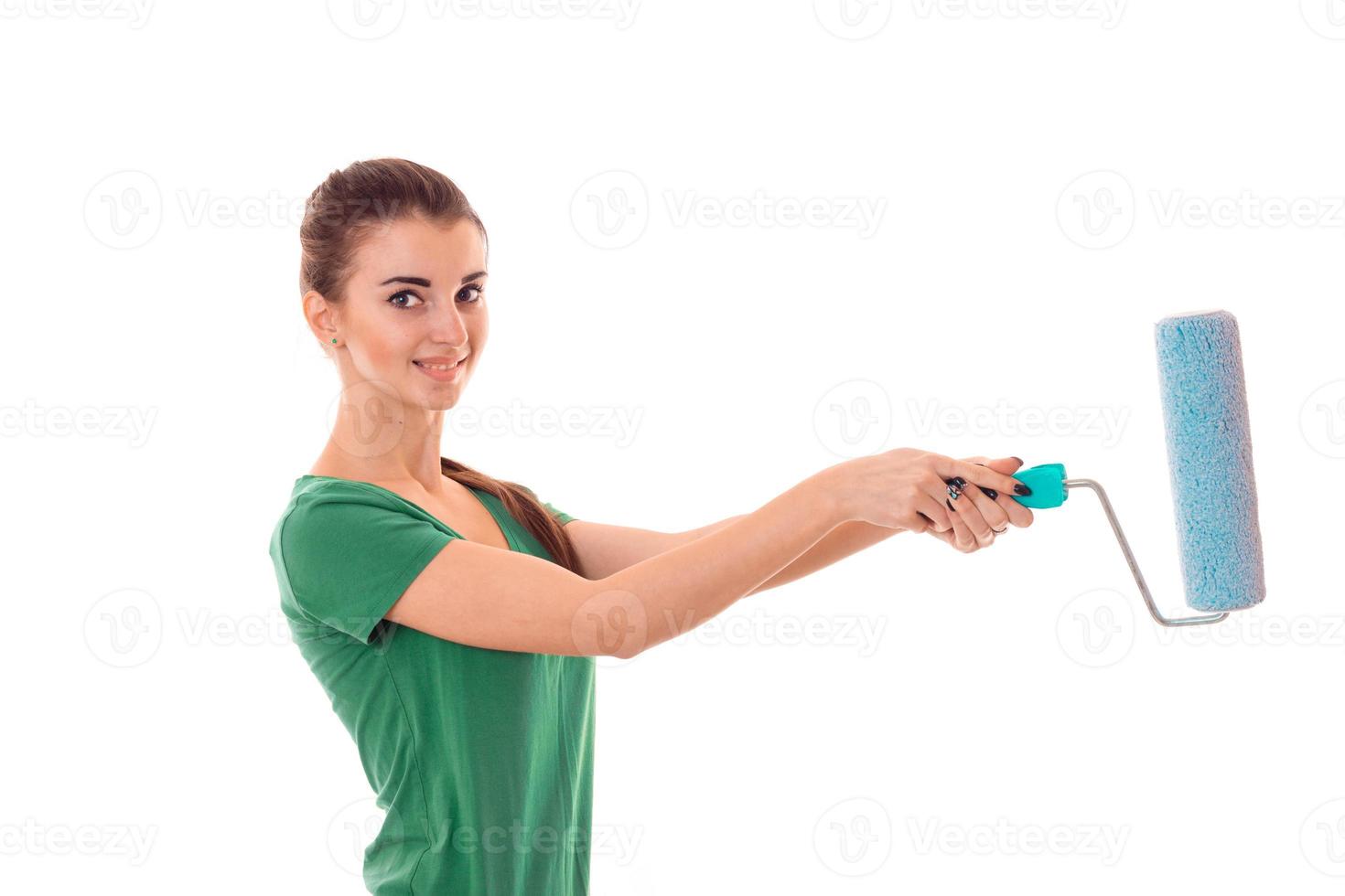 cheerful brunette lady makes refurbish an apartment isolated on white background in studio photo