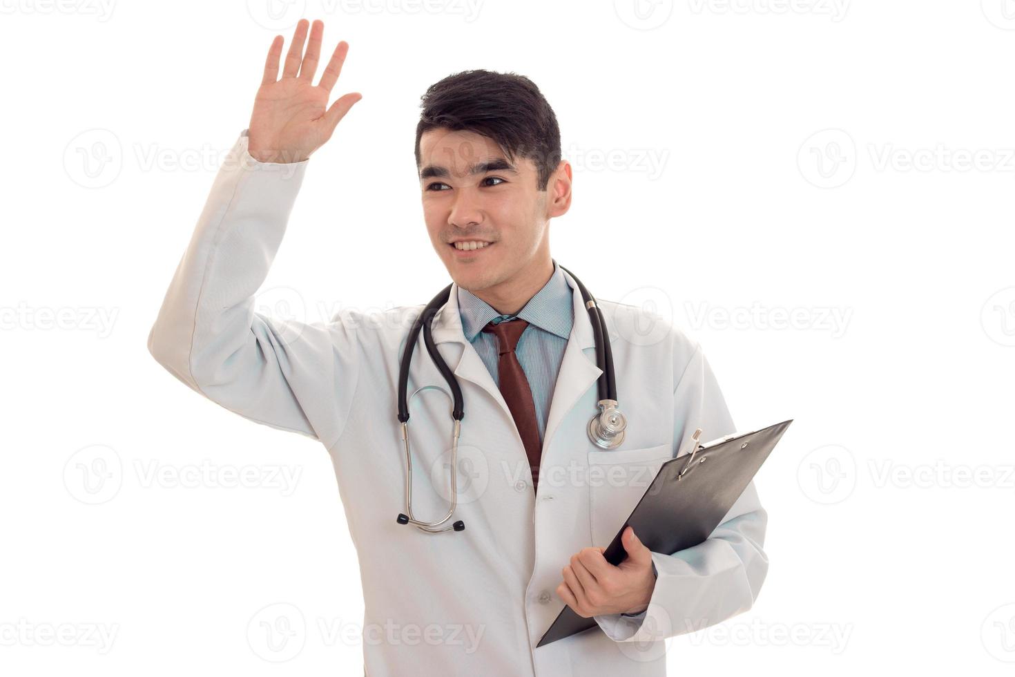 cheerful handsome man doctor posing in uniform isolated on white background in studio photo