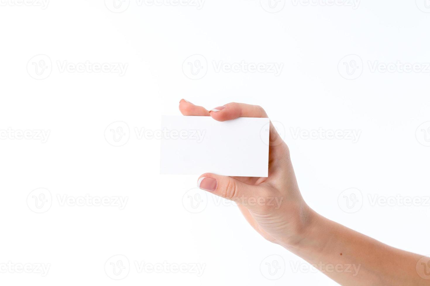 female hand outstretched to the side in which the white paper leaf isolated on  background photo