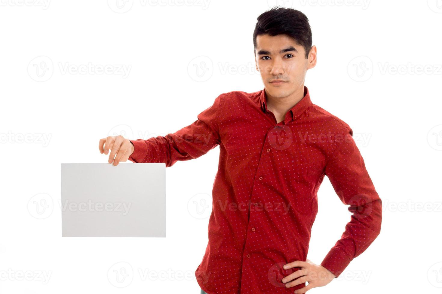 portrait of young brunette male model with placard in hands isolated on white background photo