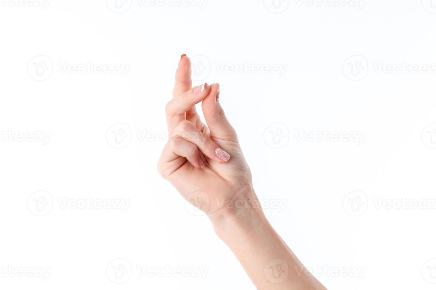 female hand showing the gesture with his fingers clasped isolated on white background photo