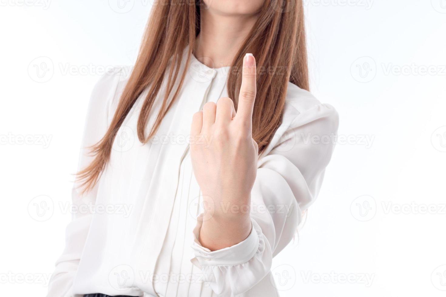 young girl is stretched out in front of  hand and shows one finger isolated on white background photo