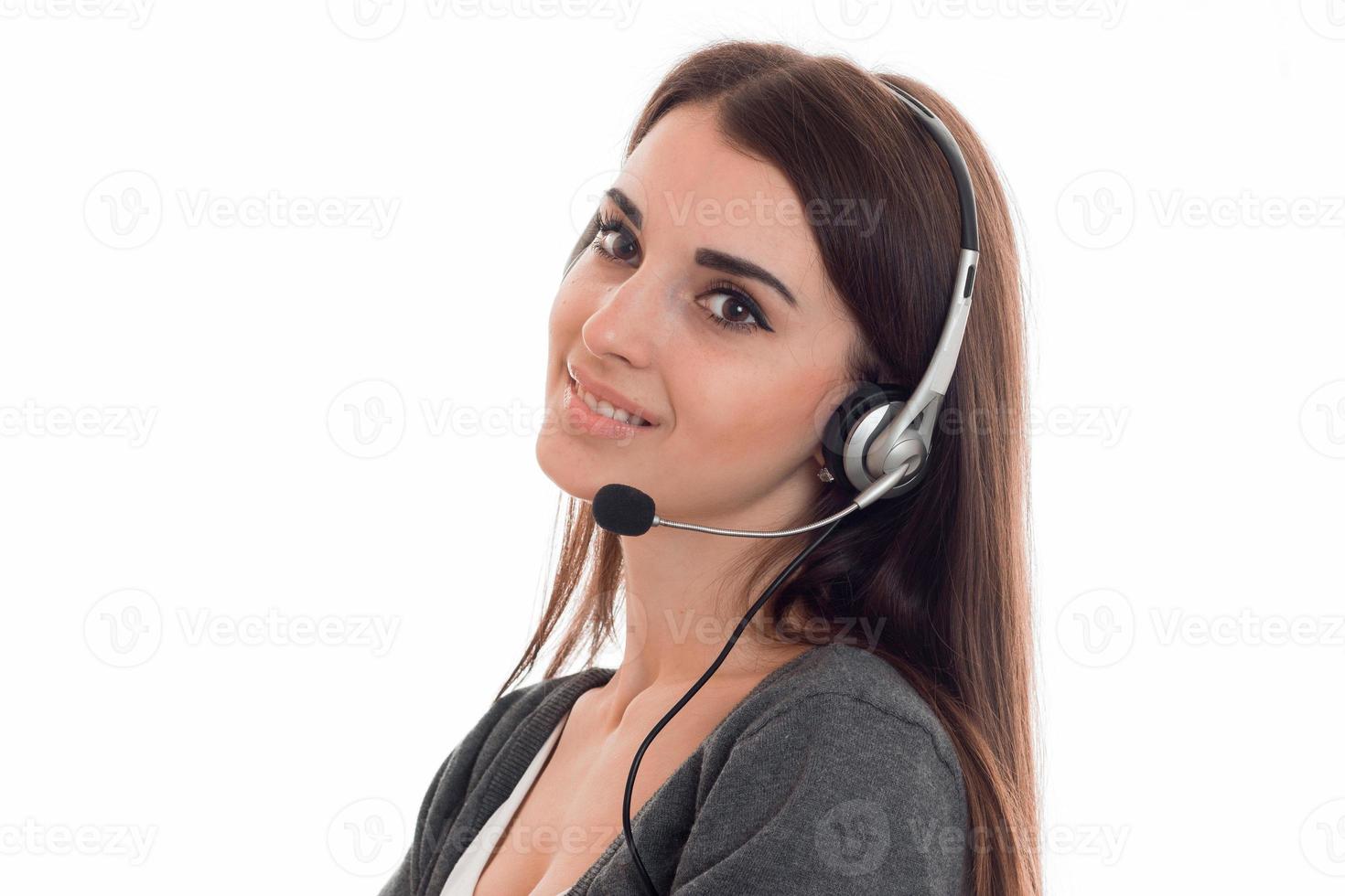 cutie young brunette call office worker woman with headphones and microphone smiling isolated on white background photo