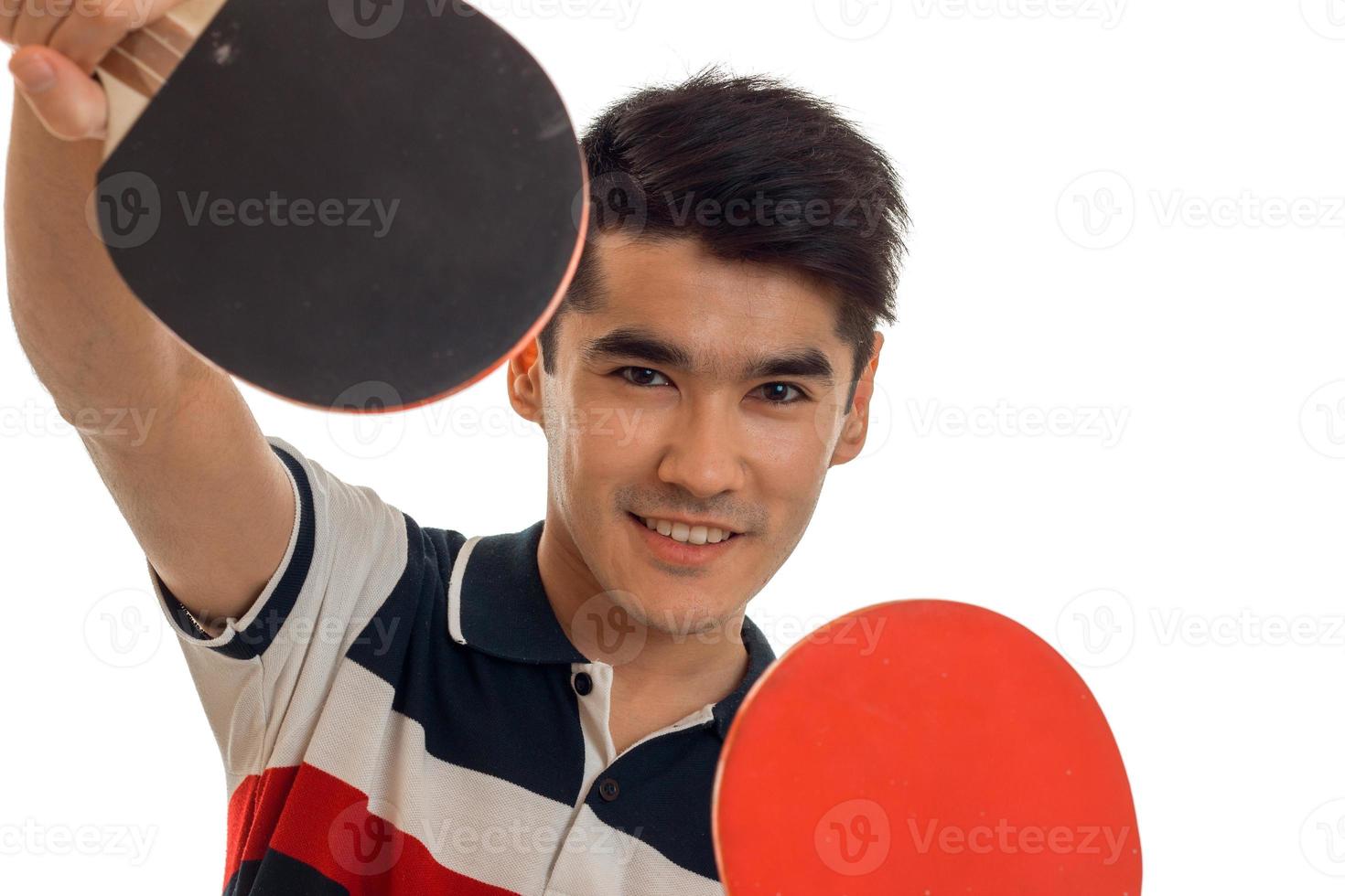 portrait of young cheerful sportsman practicing ping-pong isolated on white background photo