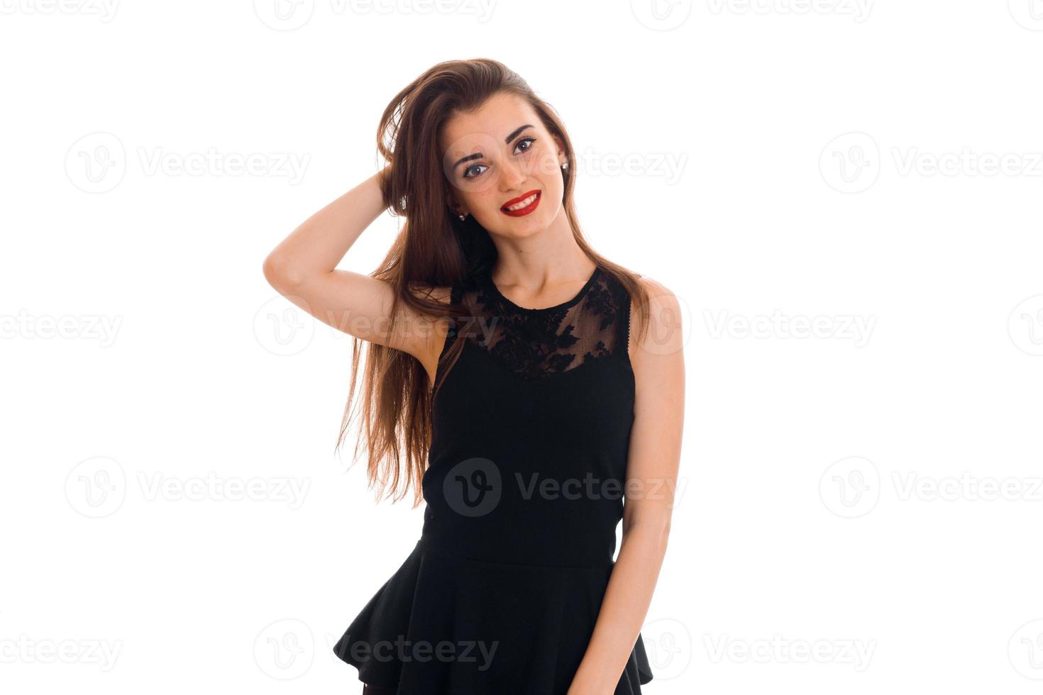 sexy young woman with red lips in black dress posing and smiling on camera isolated on white background photo