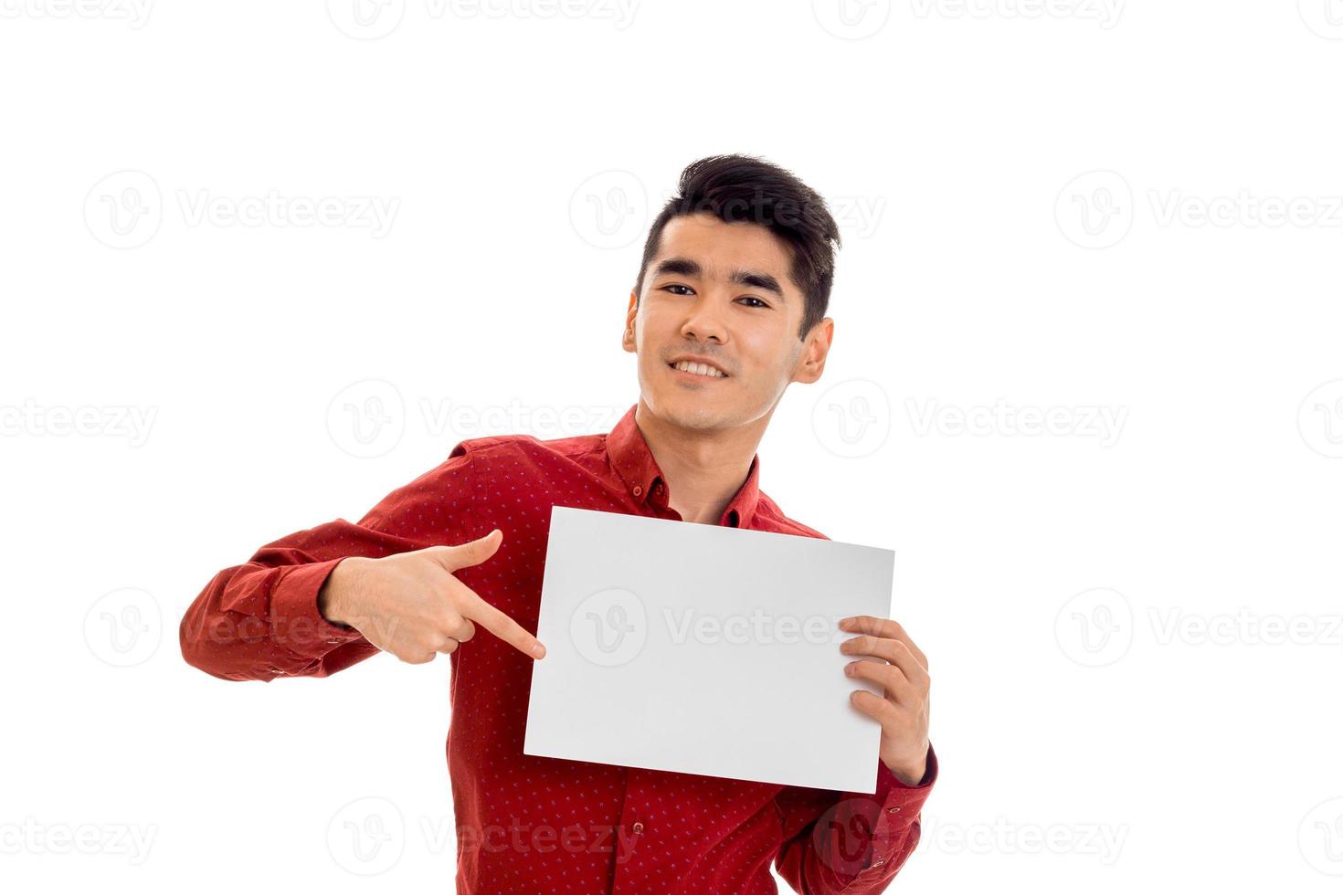 stylish young brunette man in red t-shirt with placcard in his hands isolated on white background photo