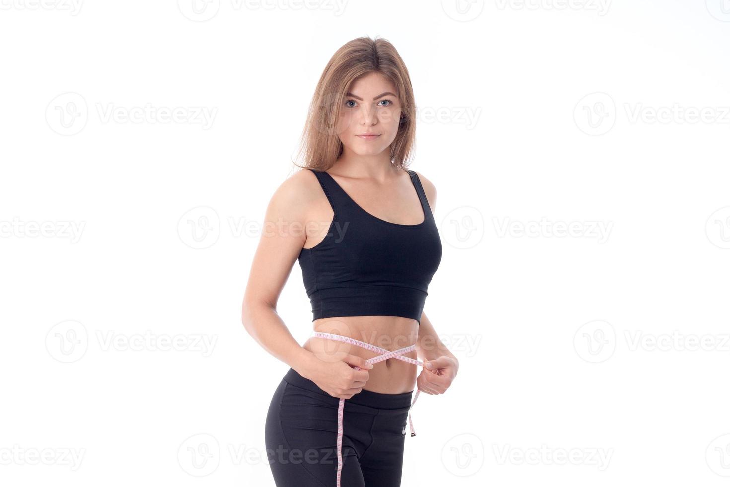 Sport girl in black top standing sideways looks forward photo