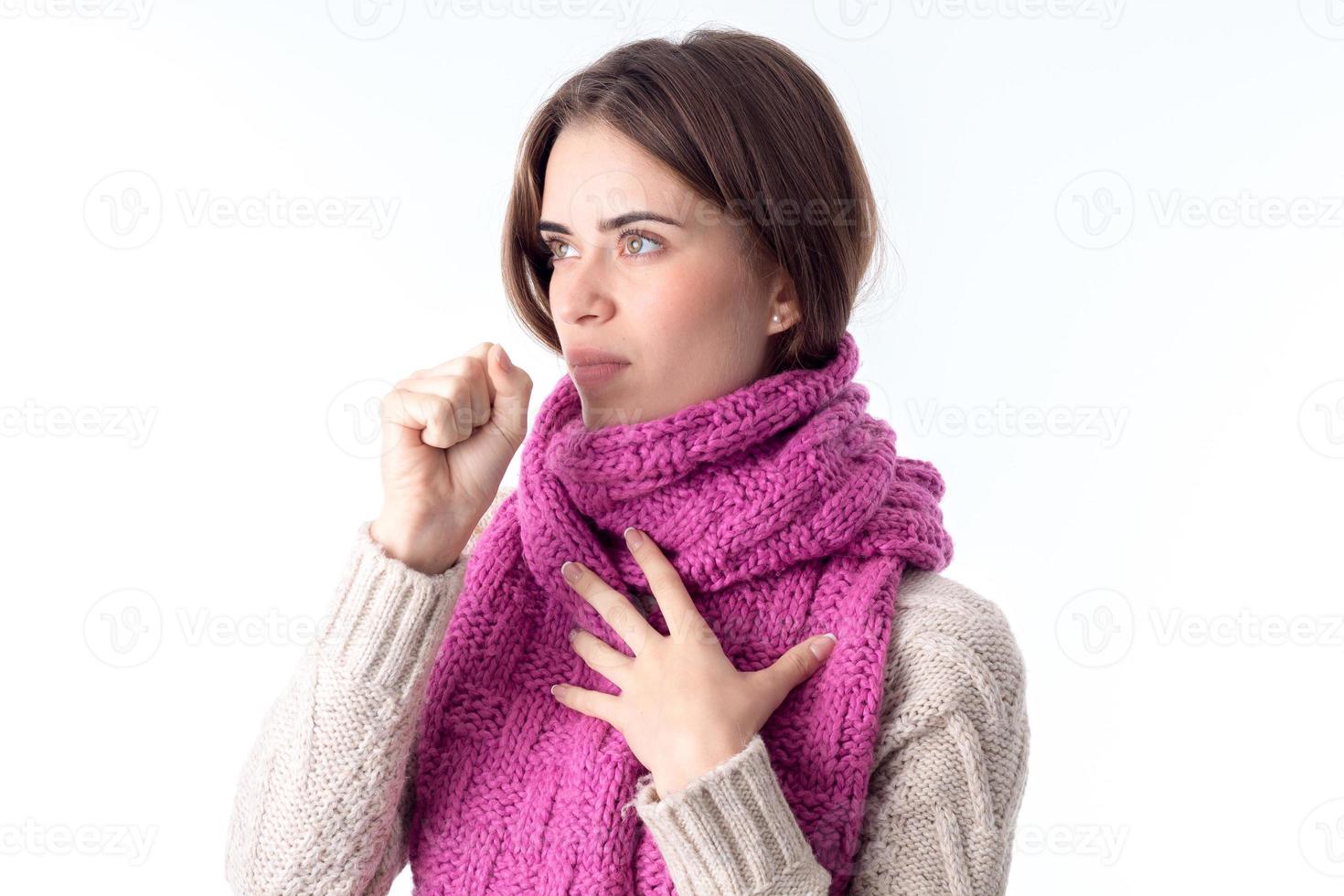 girl in  scarf worth sideways and drinking  glass of water isolated on white background photo