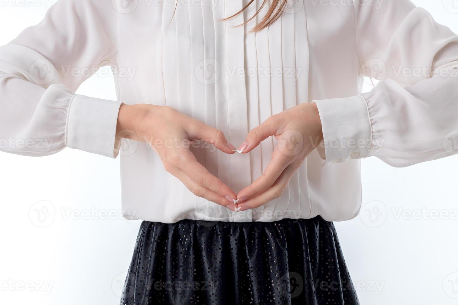 girl holds two hands sweetheart isolated on white background photo