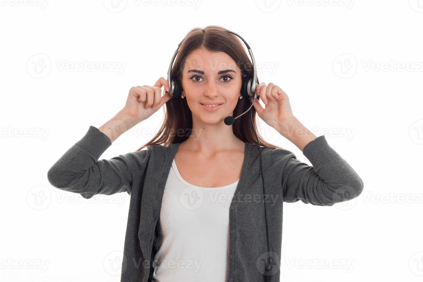 Cutie young business woman working in call center with headphones and microphone looking at the camera and smiling isolated on white background photo