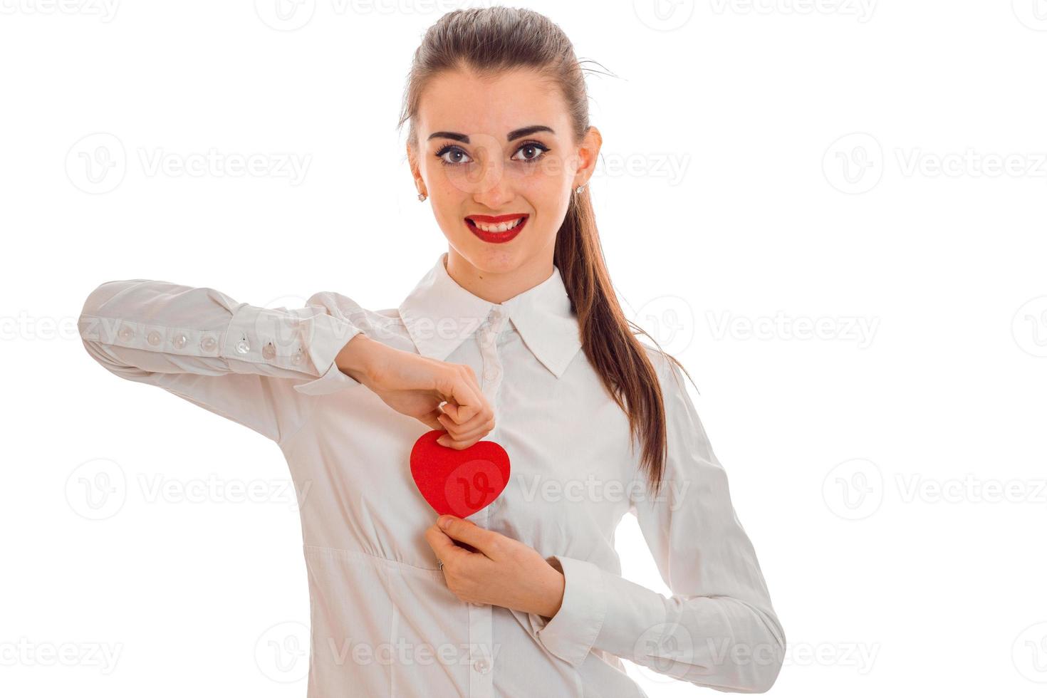 cute brunette girl in black dress with nice make up celebrate Valentines day with red heart in her hands isolated on white background photo