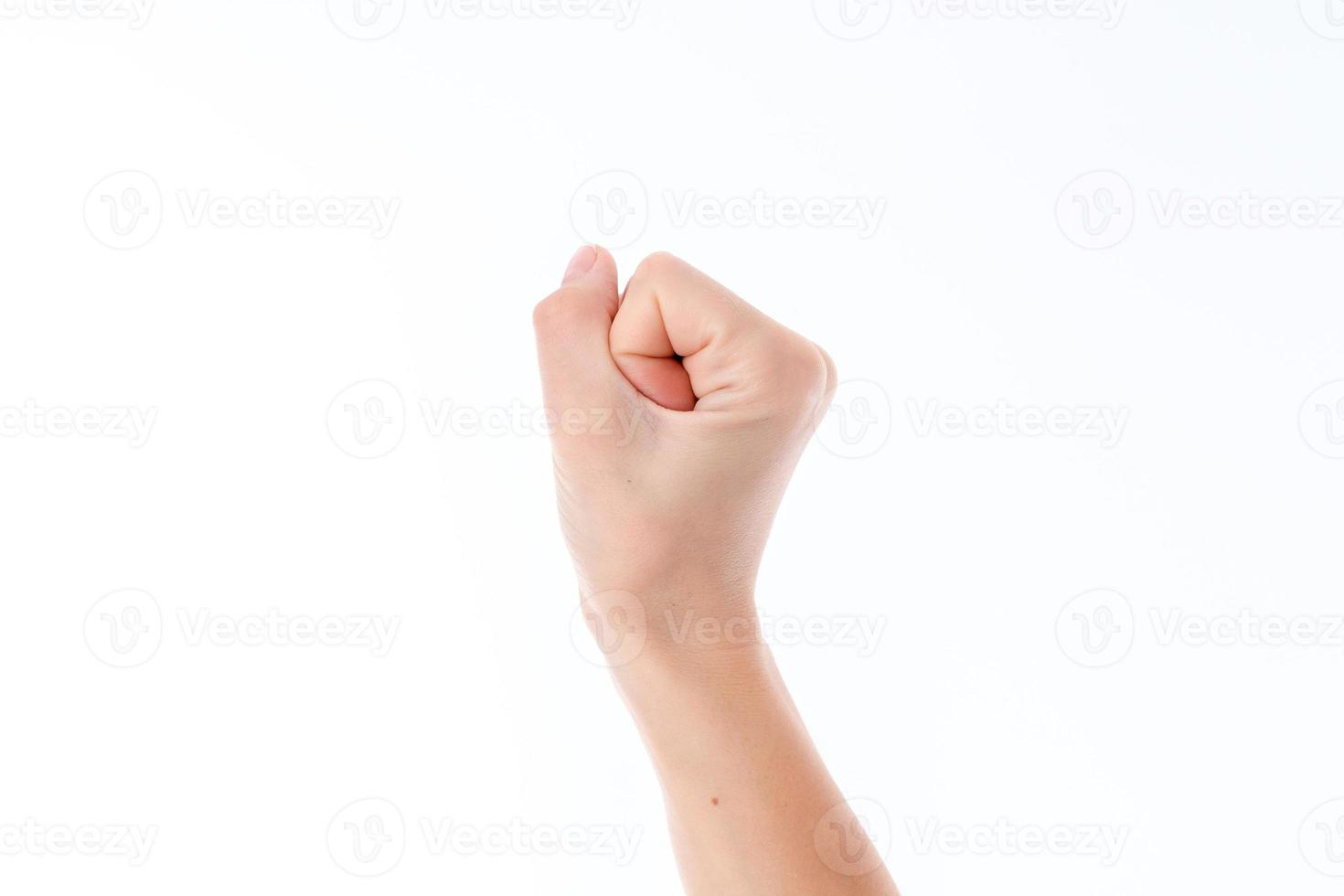 female hand raised up and showing the gesture with bent fingers isolated on white background photo