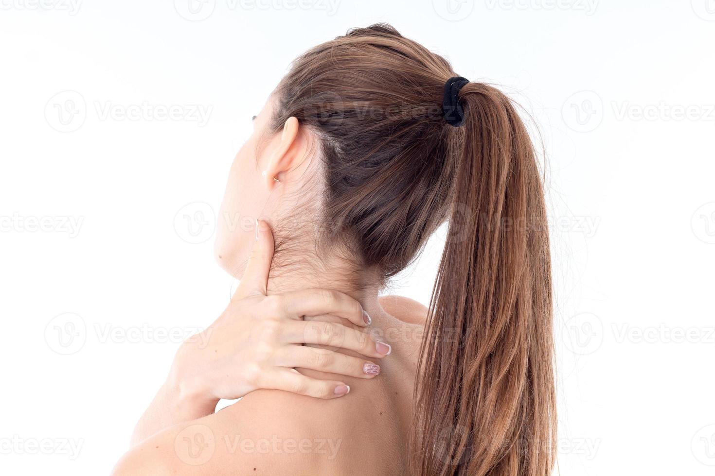 young girl stands back forward and keeps the ball over the shoulder of close-up photo