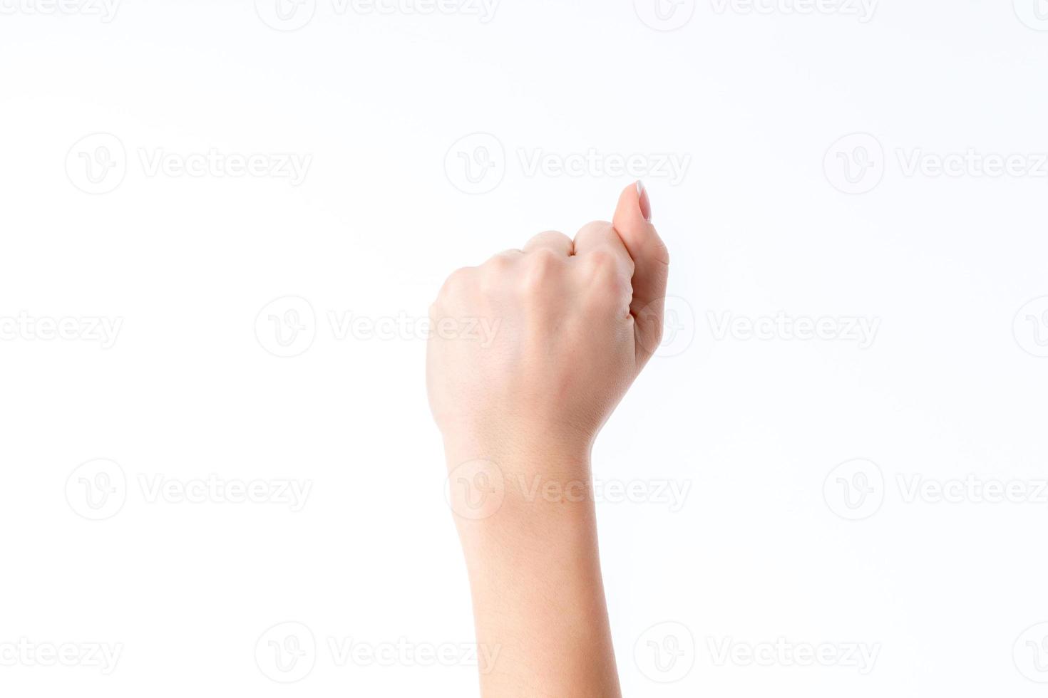 female hand raised up into a fist with bent fingers isolated on white background photo