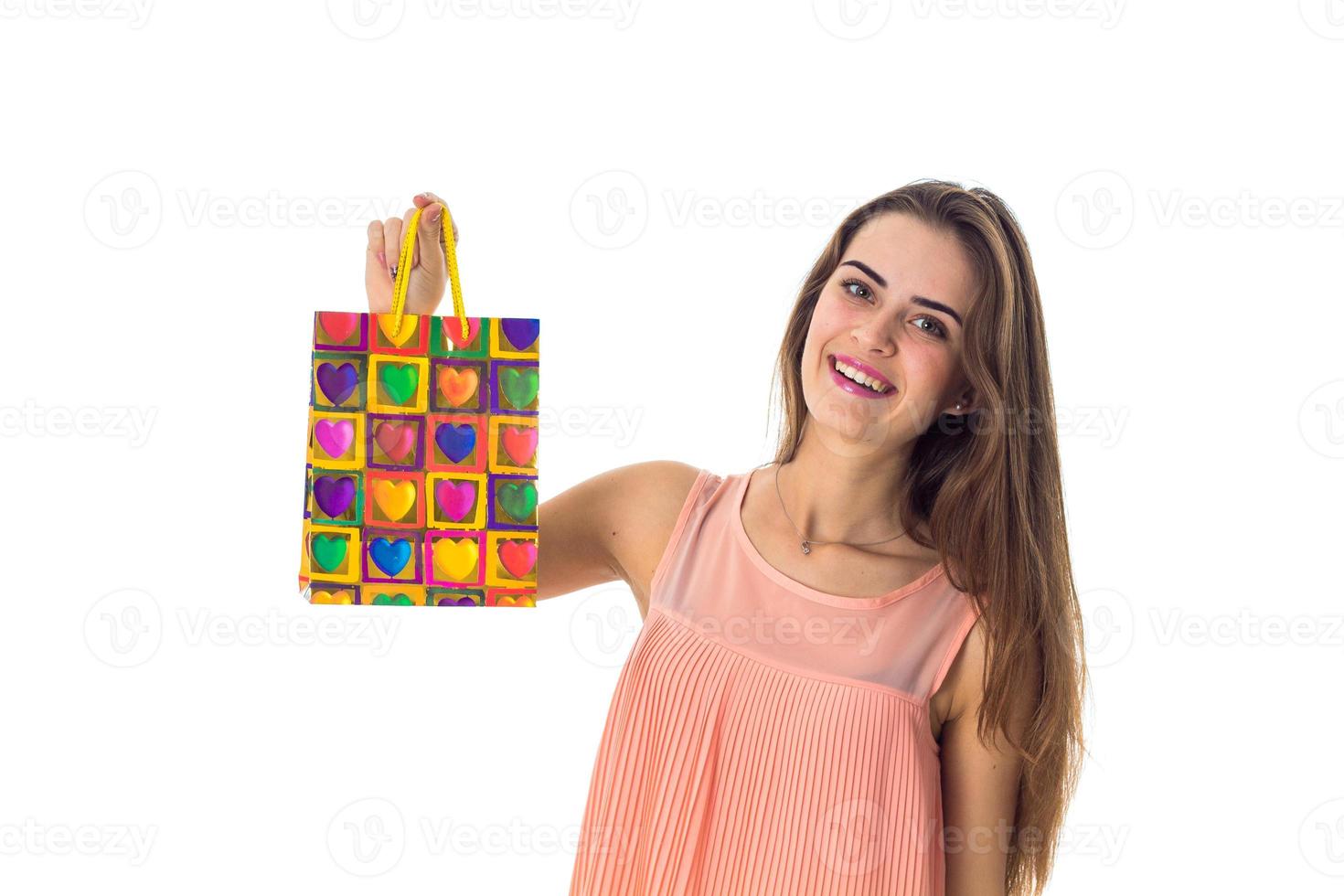 young girl raised up  beautiful gift bag isolated on white background photo