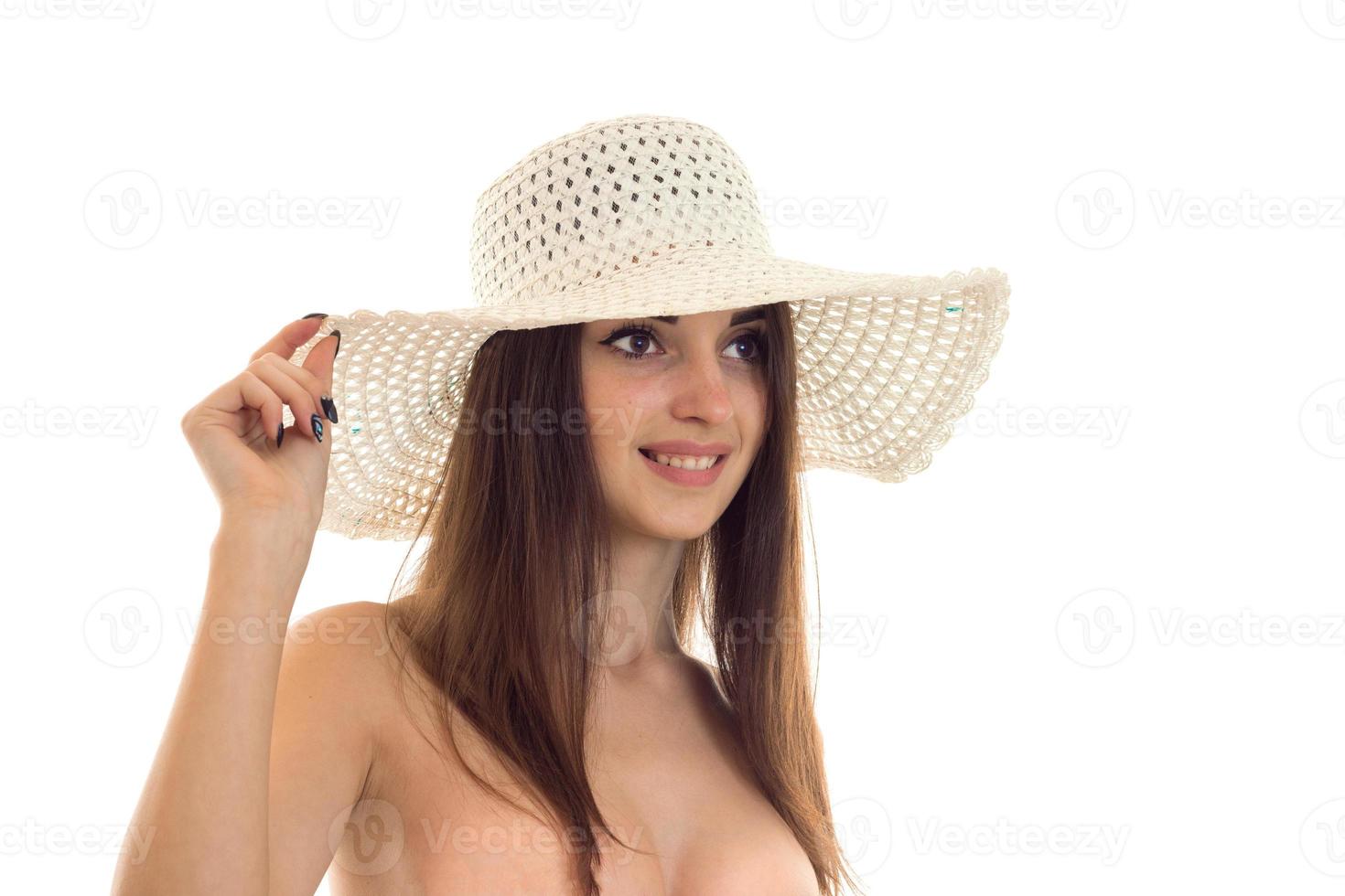 sexy young girl in the hat looks away and smiling isolated on white background photo