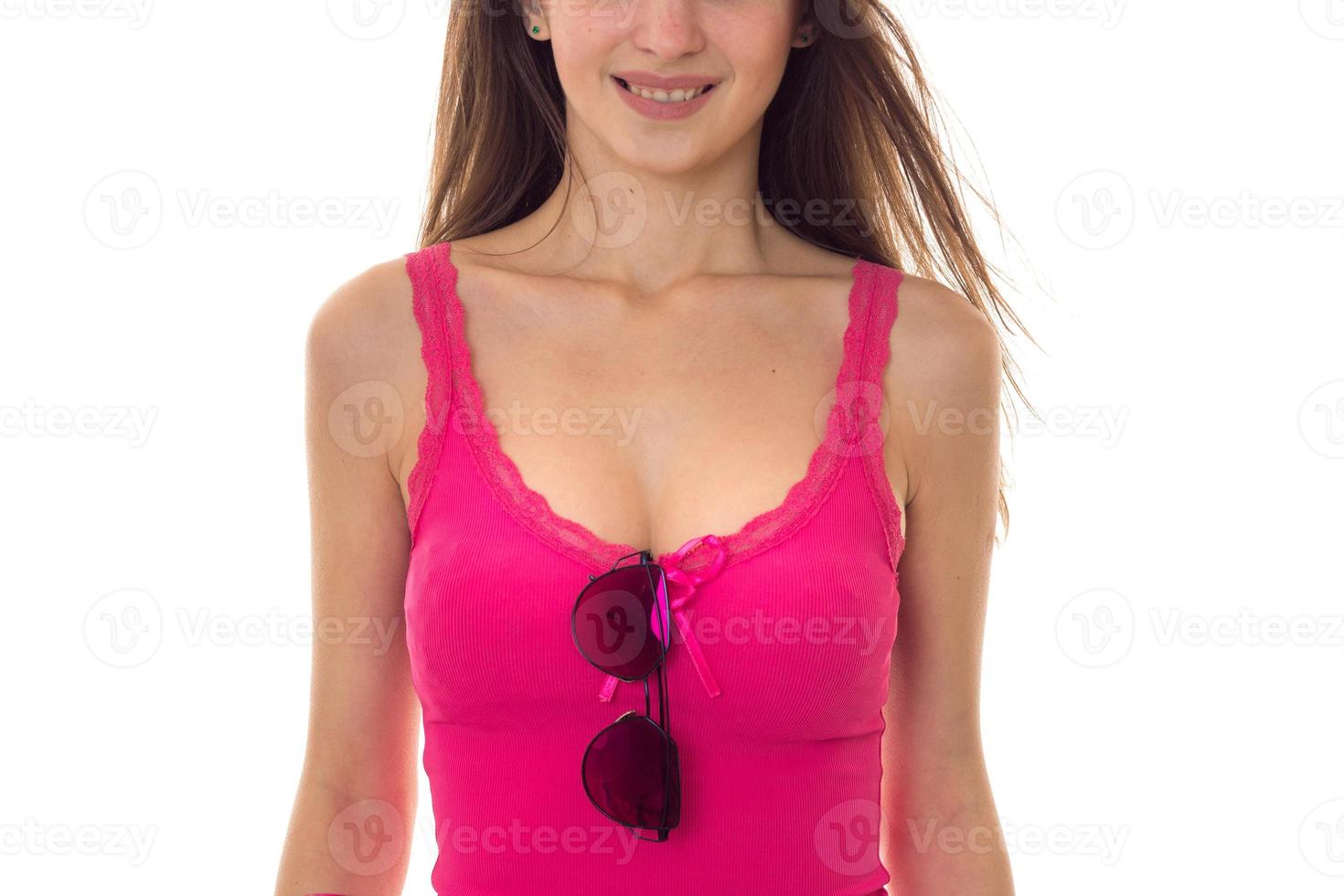 the body of a beautiful young girl in a bright t-shirt with large breasts on which to hang glasses isolated on white background photo