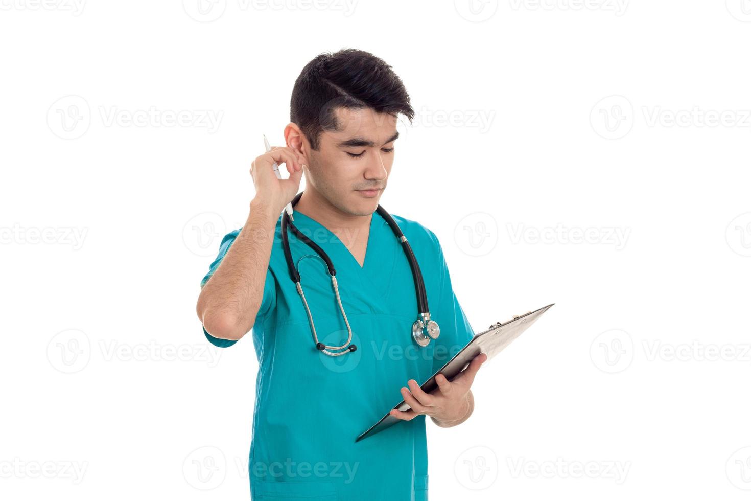 young adult doctor in blue uniform with stethoscope on his neck isolated on white background photo