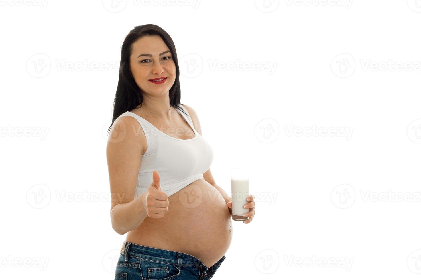 beautiful young pregnant woman shows class and looking directly photo