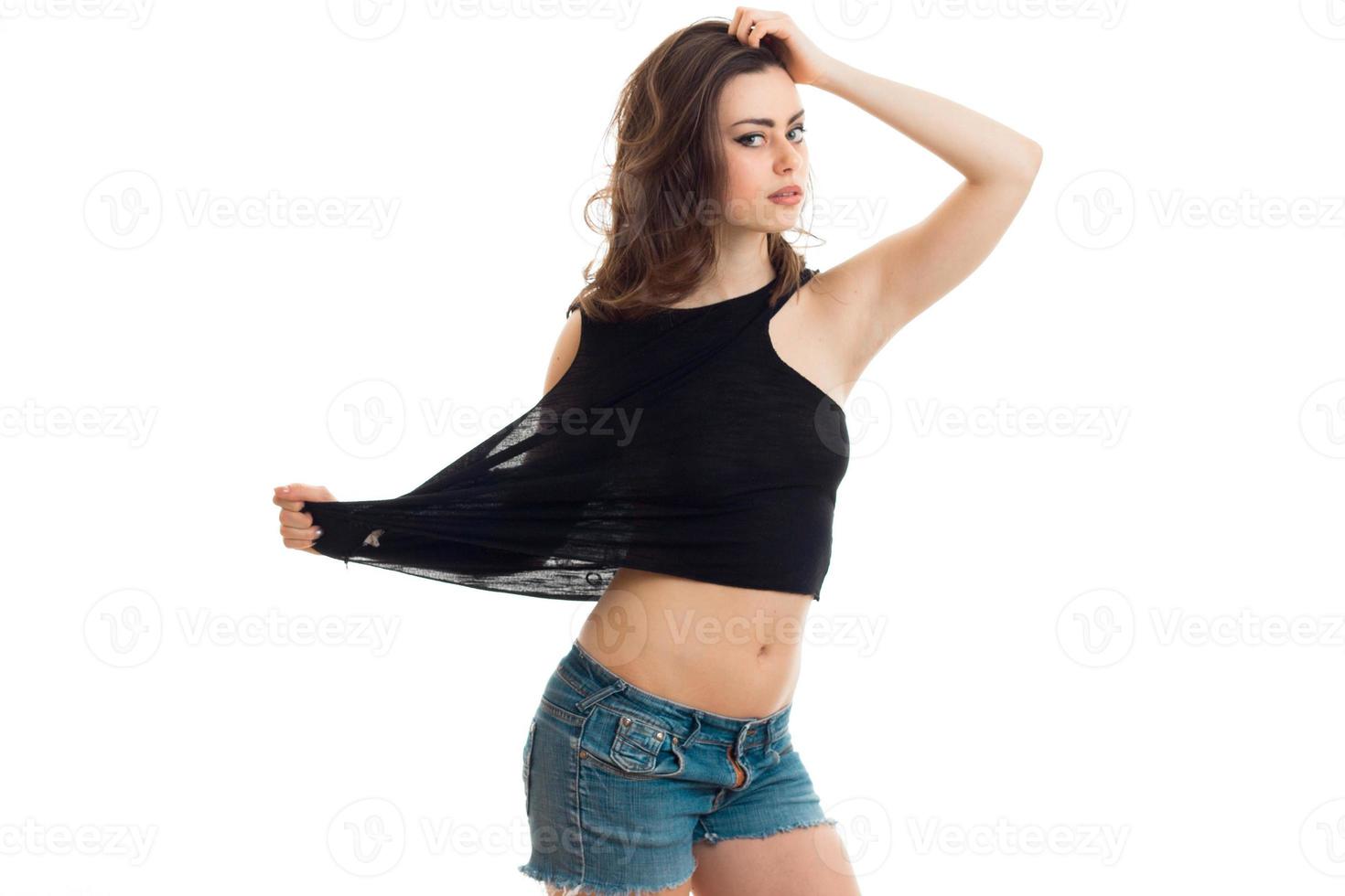 young sexy girl keeps the ball to Mike and the second hand is held behind the head photo