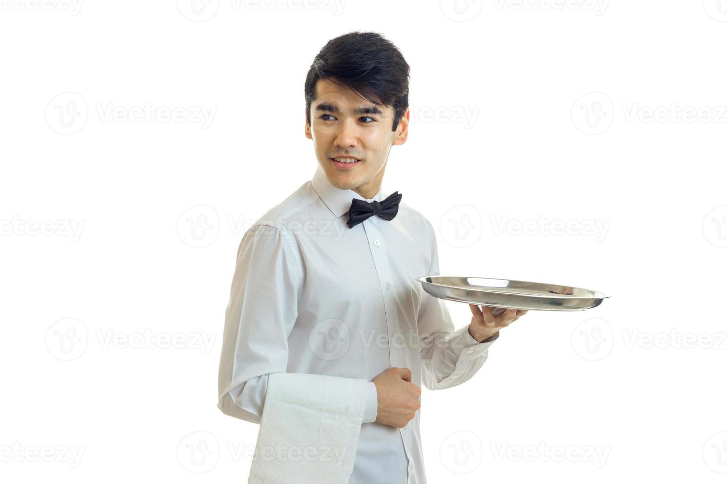 young handsome guy in a shirt holding a tray of crockery and smiling photo