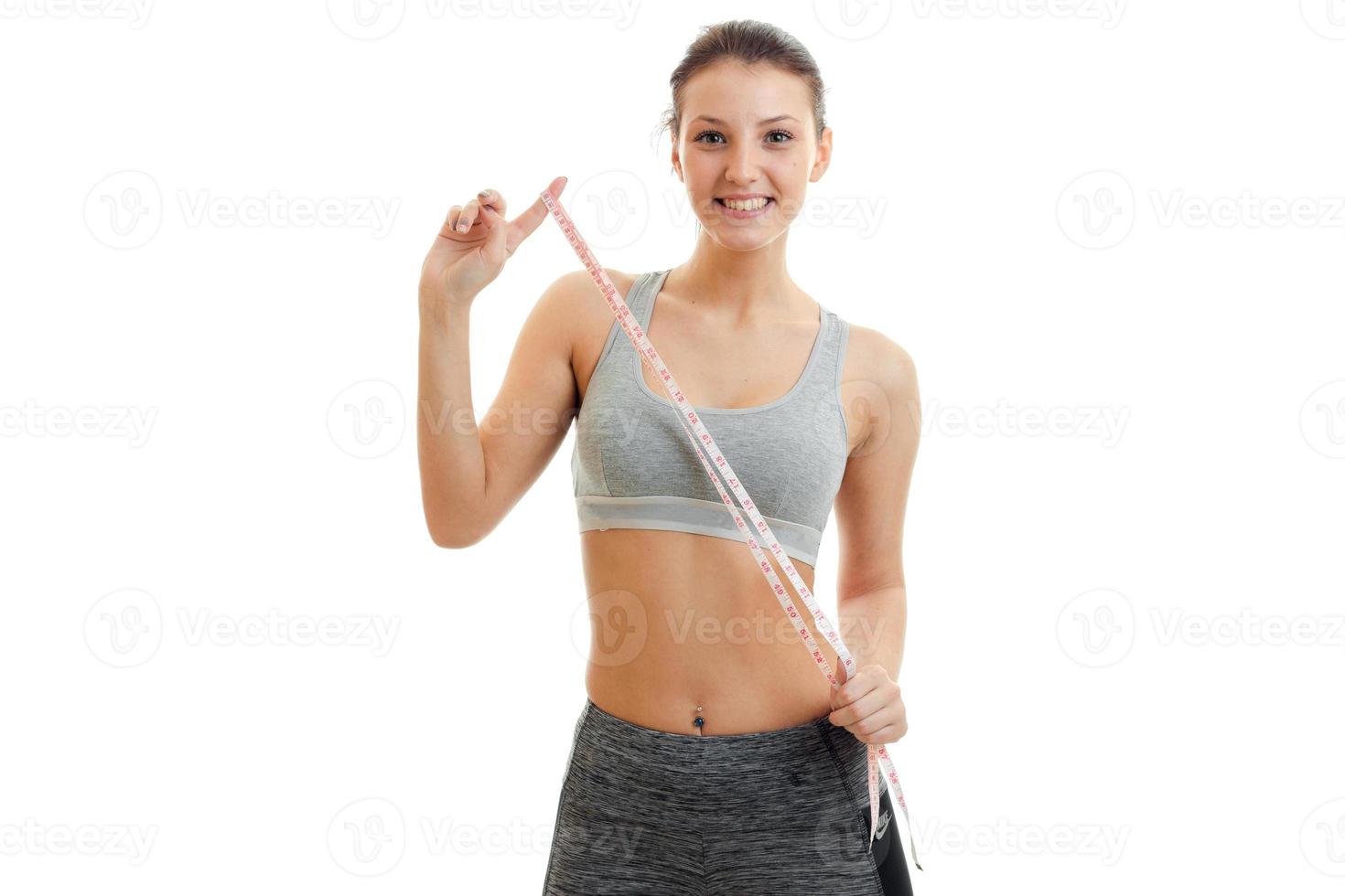 fun fitness girl grey top holding a measuring tape photo